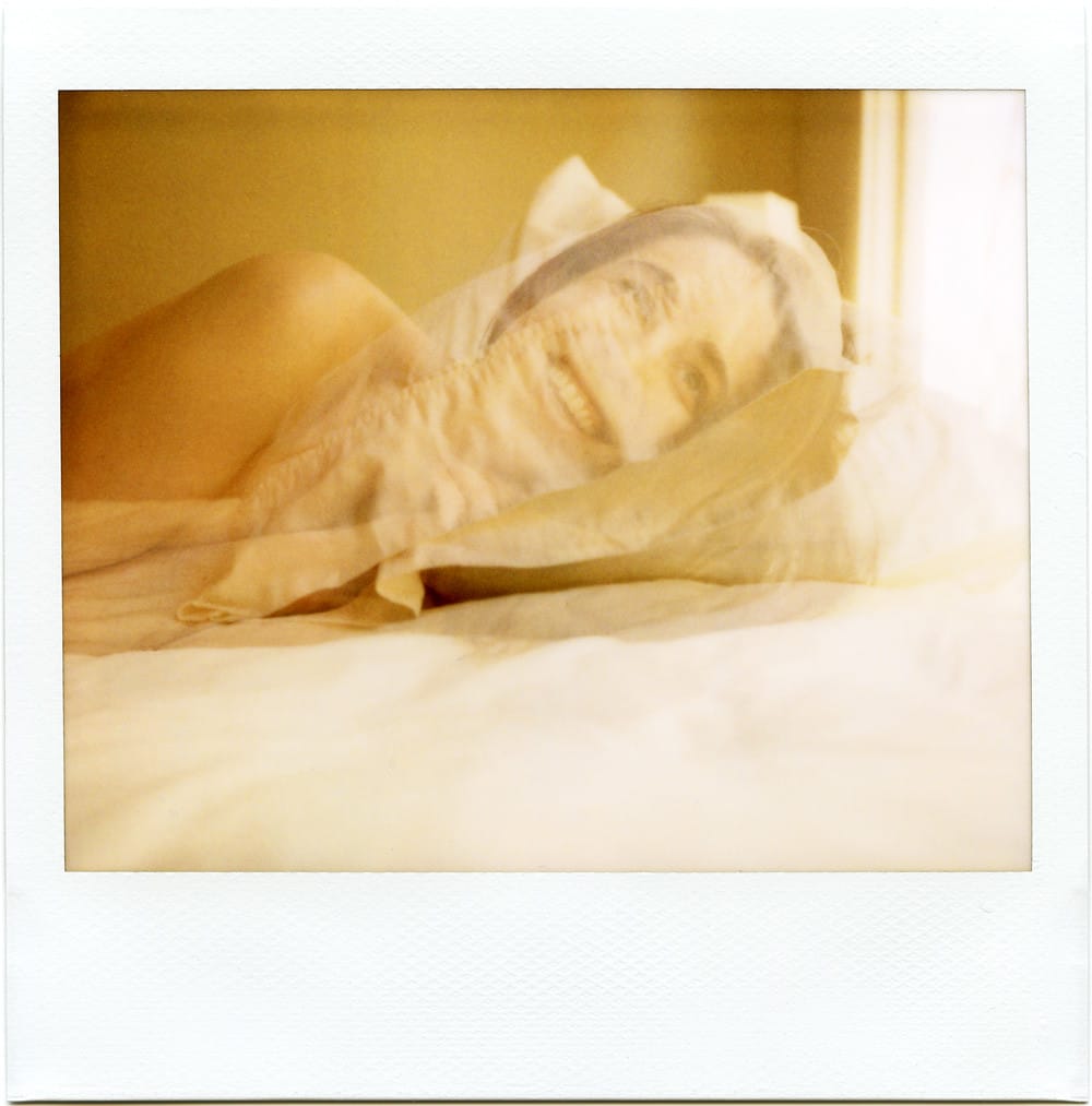 A Polaroid self-portrait double exposure in which my face is transposed over a pillow in a creepy way